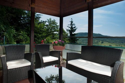 a porch with chairs and a view of the water at Albergo Ristorante il Fungo in Santa Fiora