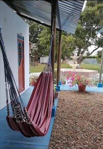 a couple of hammocks in front of a house at Hotel campestre la Maria in Villavicencio