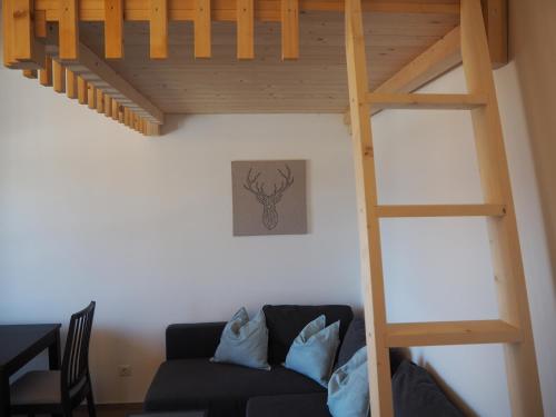 a living room with a loft bed and a couch at Ebner Appartements in Aldino