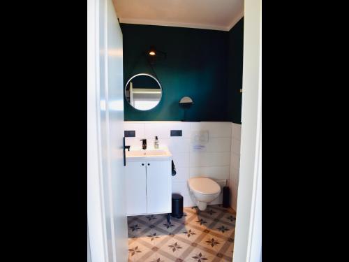 a bathroom with a white sink and a toilet at Ferienhaus M&M in Schwarz