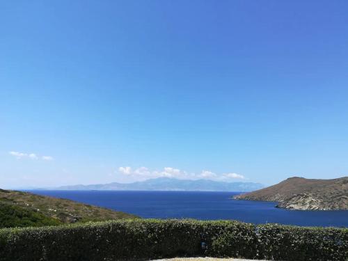 a view of a body of water from a hill at Andros Eco Home in Gavrion