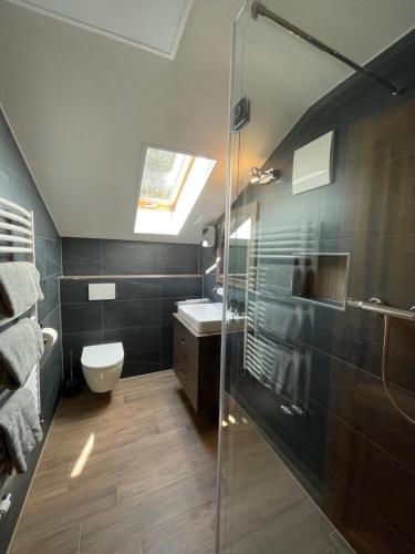 a bathroom with a shower and a toilet and a sink at Haus Freynend in Anger