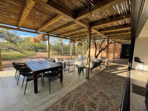 an outdoor patio with a table and chairs at Rixile Kruger Lodge in Skukuza