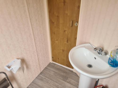 a bathroom with a white sink and a toilet at 4 Berth Golden Sands Ingoldmells (Siesta) in Ingoldmells