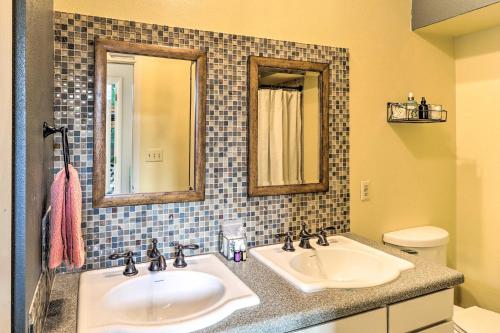 a bathroom with two sinks and two mirrors at Eureka Springs Gem 2 Decks, Mtn and Lake Views in Golden