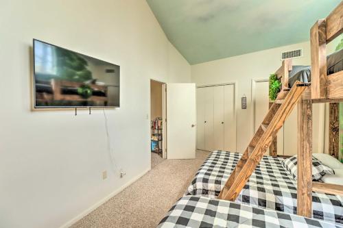 a bedroom with a bed and a tv on the wall at Eureka Springs Gem 2 Decks, Mtn and Lake Views in Golden