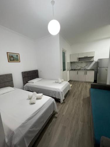 a room with two beds and a kitchen at Red Rose Guest House in Golem