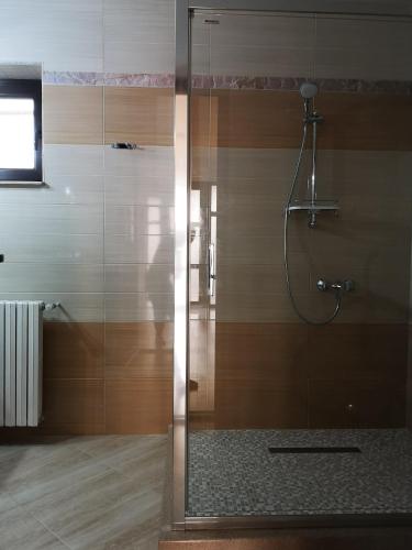 a shower with a glass door in a bathroom at Brize holiday in Tuzla
