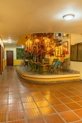 a room with a table and a tree in it at Hotel Costa mar in Barranquilla