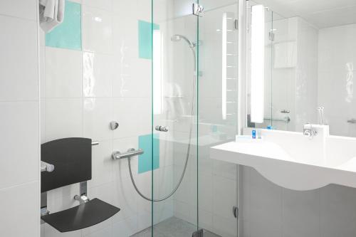 a bathroom with a glass shower and a sink at Novotel Marseille Est Porte d'Aubagne in Marseille