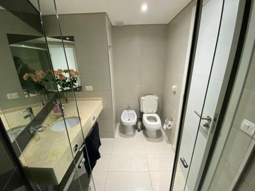 a bathroom with a sink and a toilet at Wind Tower Punta del Este in Punta del Este