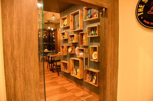 a room with a book shelf with plates on it at SILVER REGENCY in Guwahati