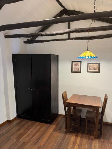 a dining room with a table and a chandelier at Casa Aranjuez in Bogotá