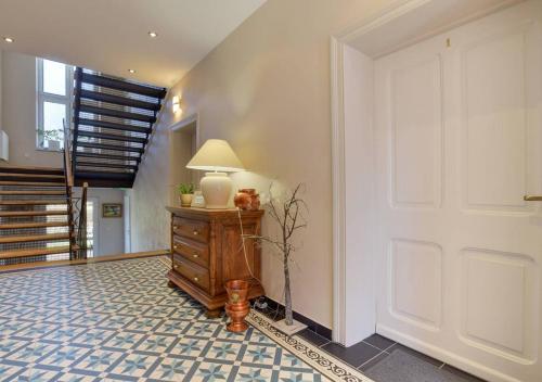 a hallway with a door and a table with a lamp at Słoneczna Willa & sauny in Kudowa-Zdrój