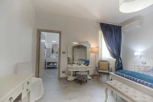 a bedroom with a bed and a sink and a mirror at Cozy guest house Downtown in Olbia