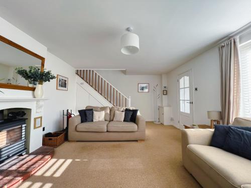 uma sala de estar com dois sofás e uma lareira em Bright & Cosy - Jacuzzi - Log Burner - King Beds em Tangmere