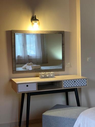 a dressing table with a mirror on a wall at Sofia's House in Sivota
