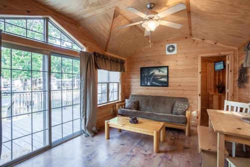 a living room with a couch and large windows at Pine Haven in Cape May Court House