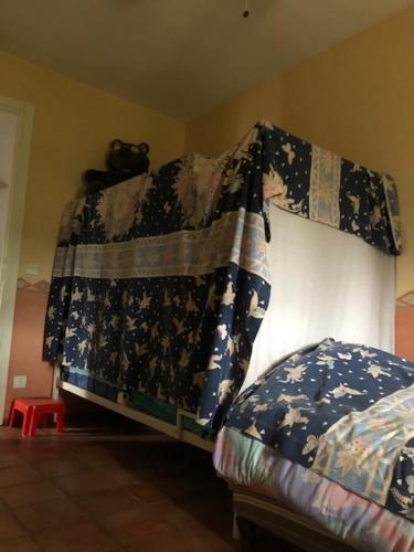 a bedroom with a bed with a blanket on it at Domaine Sagittaires in Le Cannet-des-Maures