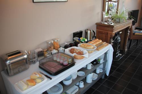 a white table with food on top at Au Coeur Des Hôtes in Steenvoorde
