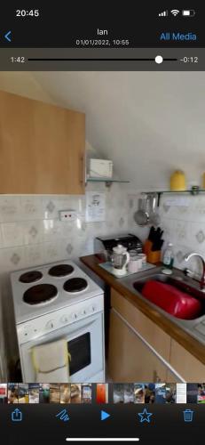 a kitchen with a stove and a sink at 2 Bedroom Holiday Apartment Skegness - Flat 17 in Skegness