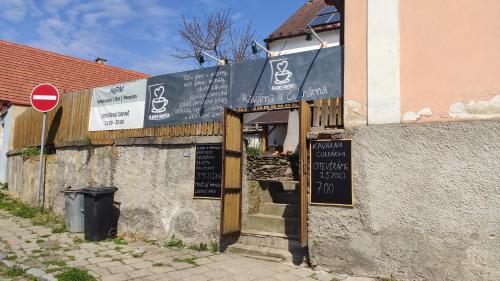 a building with a sign on the side of it at H@M Penzion in Žlutice