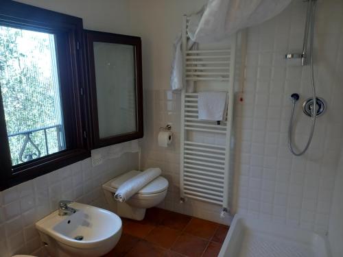 a bathroom with a toilet and a sink and a shower at La casa di Elda in Sanremo