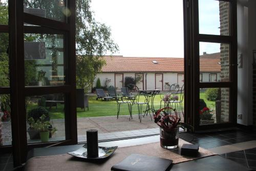 an open window with a view of a patio at Au Coeur Des Hôtes in Steenvoorde