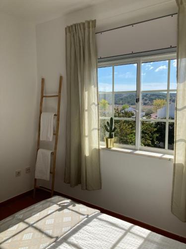 a room with a window with a view of the countryside at Guesthouse Releash Aljezur in Aljezur