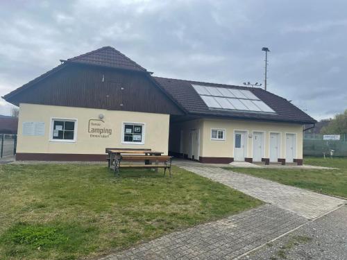 a building with a picnic table in front of it at Donaucamping Emmersdorf in Emmersdorf an der Donau