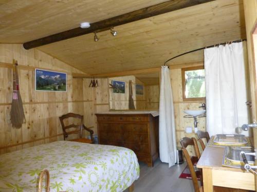 una camera con letto, scrivania e lavandino di CABANE perchée dans les arbres et terrasse ensoleillée a Robion en Luberon