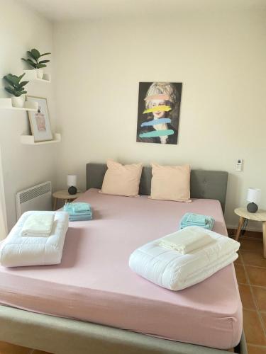 a large pink bed with two pillows on it at Château de Charme in Vallon-Pont-dʼArc