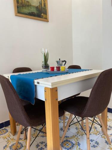 a dining room table with chairs and a blue table cloth at a Casa dei Sasso in Positano