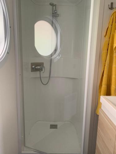 a shower with a glass door in a bathroom at Chalet Max I in Helming