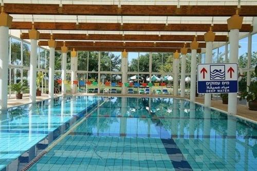 a large swimming pool in a large building at lasuita-exclusive suites ceserea-luxury suite in Caesarea