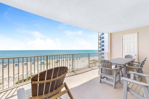 a balcony with a table and chairs and the ocean at Regency Isle 411 in Orange Beach