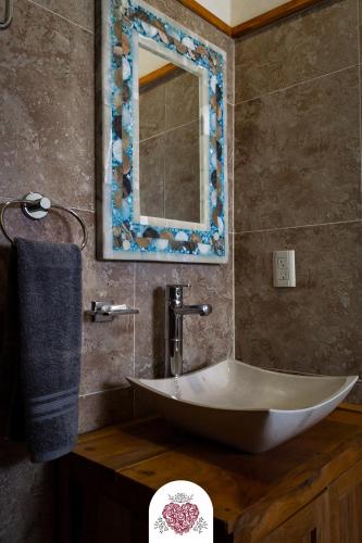 a bathroom with a sink and a mirror at Hotel Corazón de Plata Centro in Guanajuato