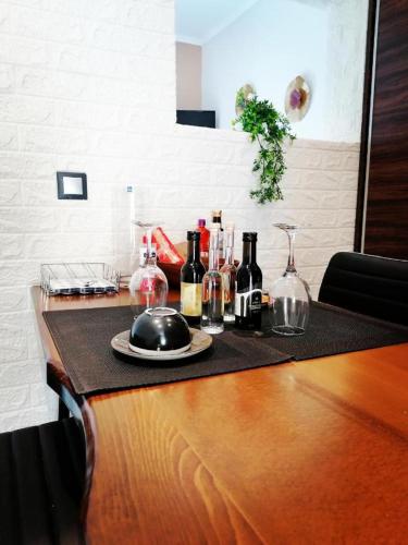 a counter with bottles and glasses and a plate on it at ΕΚΑLI ROOMS APARTMENTS in Kalentzi