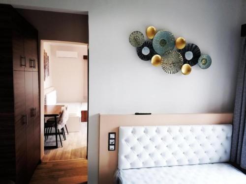 a bedroom with a bed with a heart wall decoration at ΕΚΑLI ROOMS APARTMENTS in Kalentzi