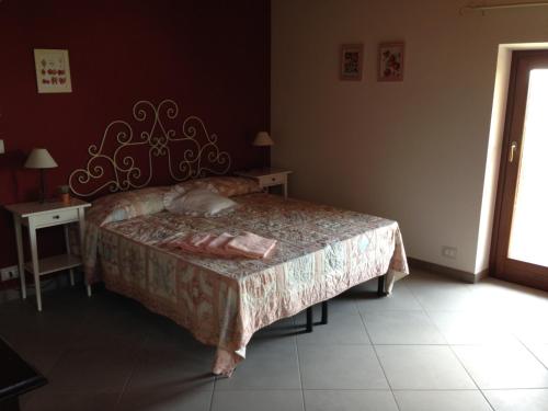a bedroom with a bed and a table and a window at Agriturismo Fruttirossi in Trofarello