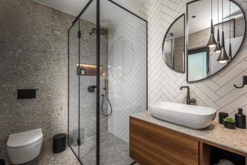 a bathroom with a sink and a glass shower at Villa Ameli Apartment with swimming pool in Rijeka