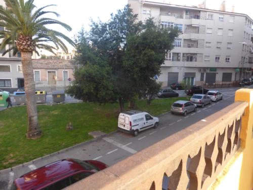 a view from a balcony of a street with parked cars at Vacaciones tierra y mar Casa en el centro con patio y terraza in El Campello