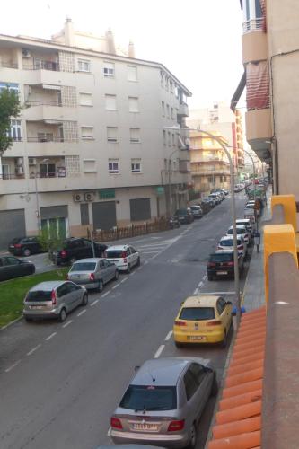 a street with cars parked on the side of the road at Vacaciones tierra y mar Casa en el centro con patio y terraza in El Campello