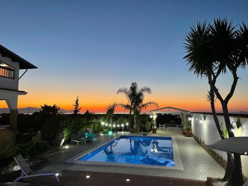 a house with a swimming pool at night at Casa Vacanze Belvedere in Partinico