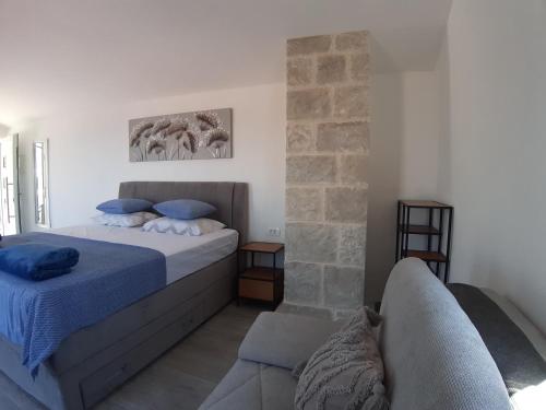 a bedroom with a bed and a couch at Olive Stone House in Makarska
