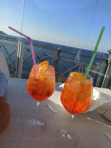 two drinks in glasses sitting on a table at Casa Vacanze Belvedere in Partinico