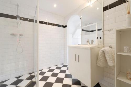 a white bathroom with a shower and a sink at Casa Qirih in Zierikzee