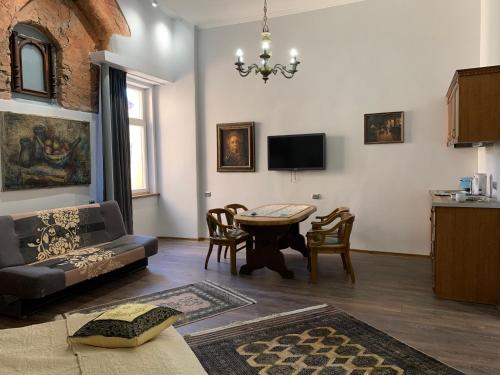 a living room with a couch and a table at NB Apartments Riga Old Town in Riga