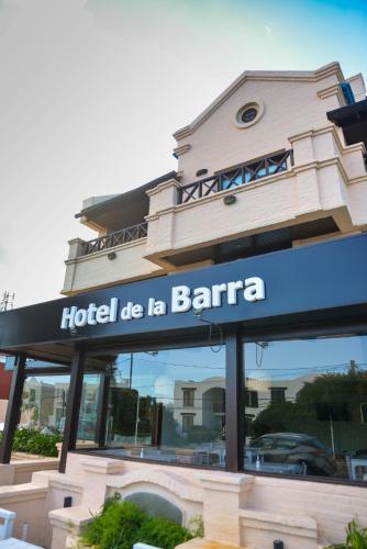 a hotel die la barra sign in front of a building at Hotel De La Barra in Punta del Este