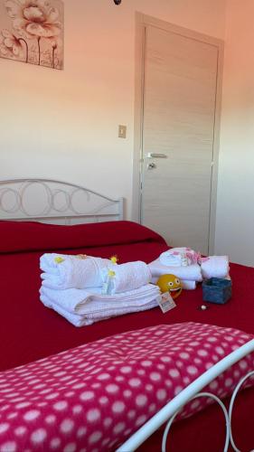 a bedroom with a bed with towels on it at B&B Marrelli Crotone in Crotone